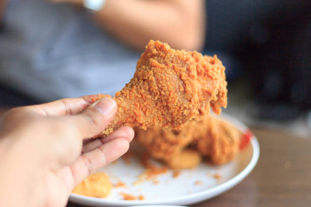 istock Fried chicken in young man hand select focus, Hand with fried chicken blur background, Close-up Fried chicken Blured or blur soft focus 854472432