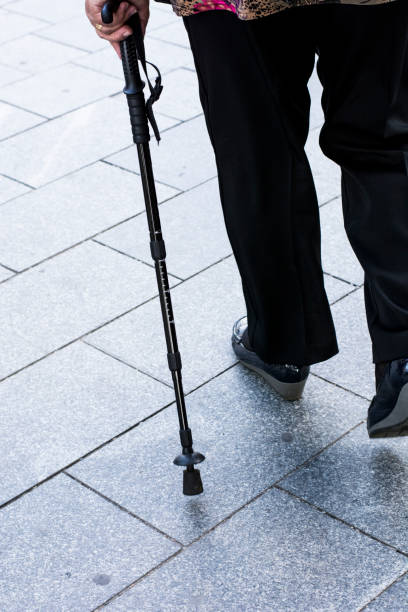 istock Senior woman walking with stick 854472592
