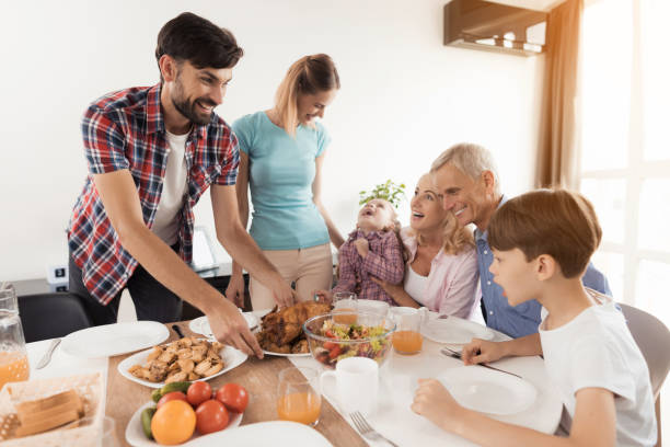istock A man with a woman serves a festive dinner on the table, for Thanksgiving 854479600