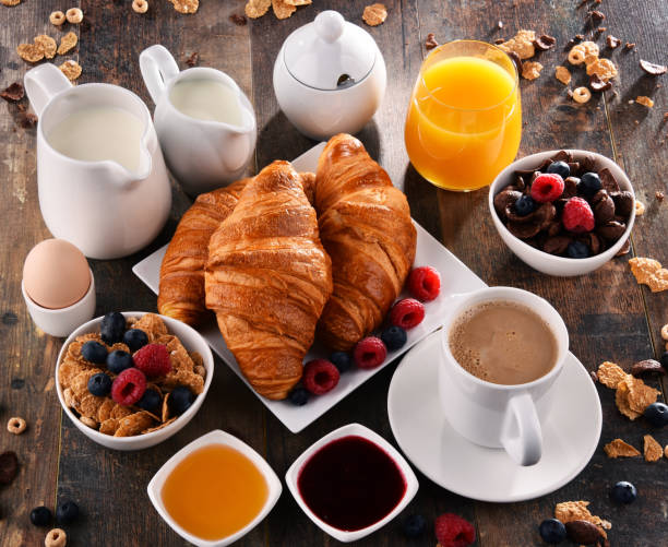 istock Breakfast served with coffee, juice, croissants and fruits 854480310