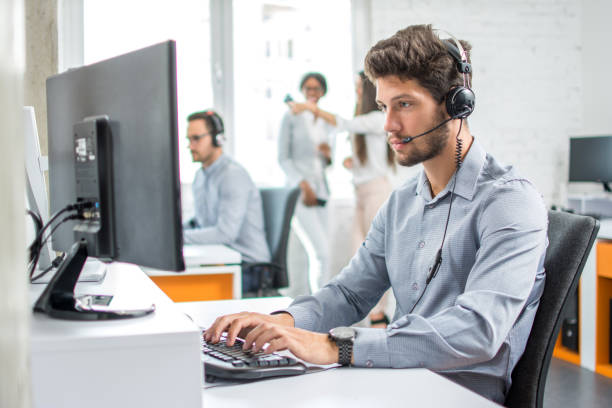 istock Young handsome male customer support phone operator with headset working in call center. 854480672