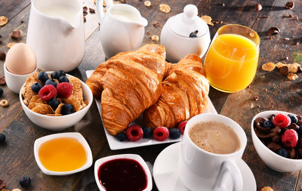 istock Breakfast served with coffee, juice, croissants and fruits 854481090