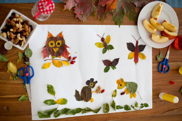 istock Sweet child, boy, applying leaves using glue 854483924
