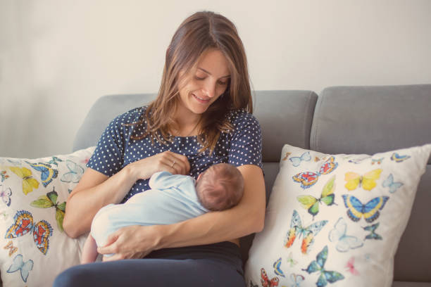 Young mother breastfeeding  her newborn baby boy