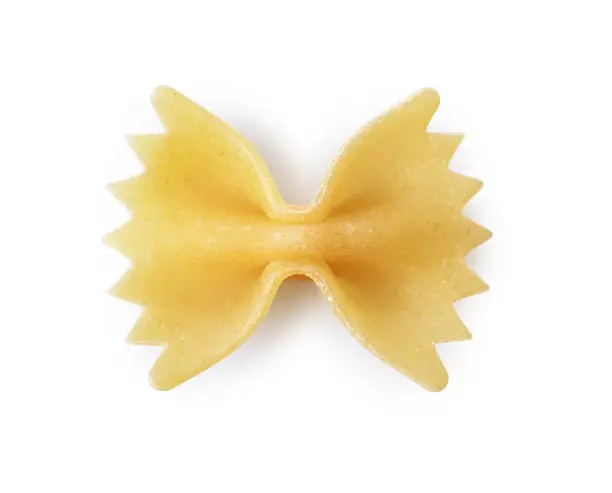 Close-up farfalle. Traditional shape of dry uncooked whole wheat Italian pasta isolated on white background