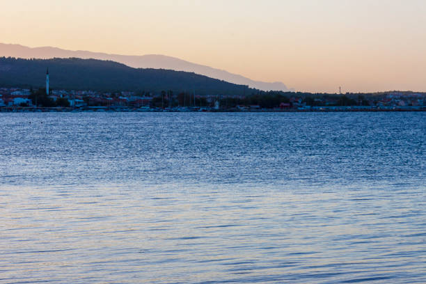 Sunset panorama on the turkish aegean coast The sunset is coming on the coast of Cesmealti (Izmir - Turkey). Panorama is wonderful, colored in blue and red and orange Izmir stock pictures, royalty-free photos & images