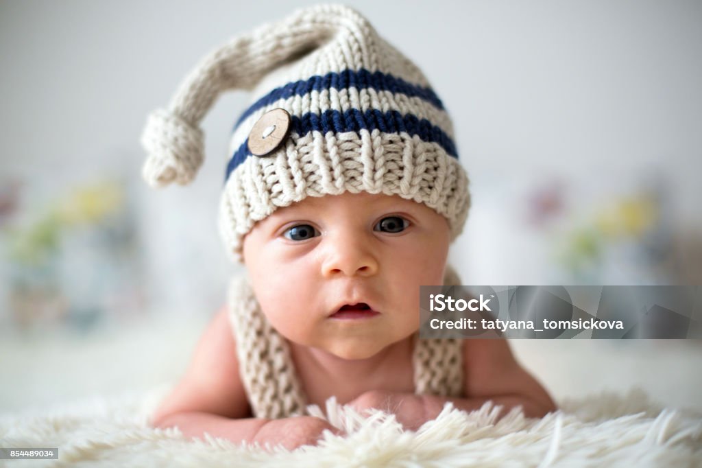 Little newborn baby boy, looking curiously at camera Little newborn baby boy, looking curiously at camera, at home in bed Baby - Human Age Stock Photo