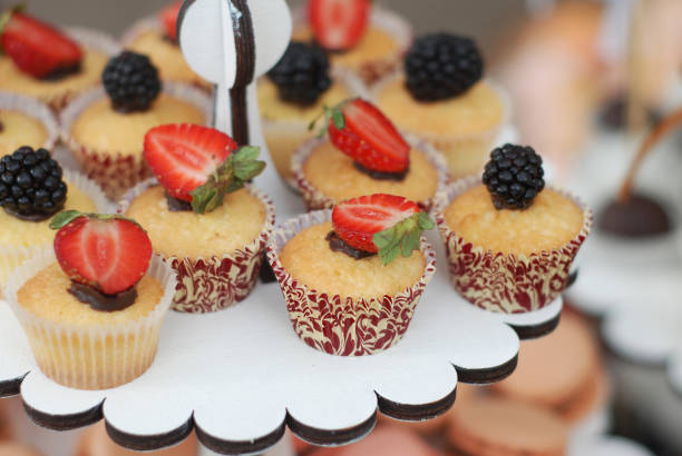 istock Delicious cupcake with berries and fresh mint on wooden table close up 854489852