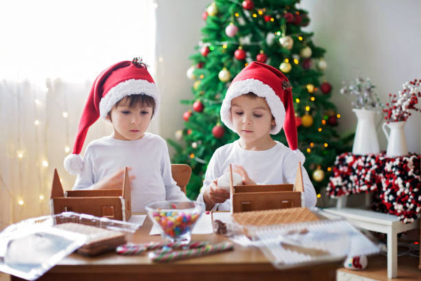 istock Two sweet boys, brothers, making gingerbread cookies house 854494300