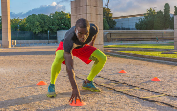 male muscular training ladder to the ground and cones. stock photo