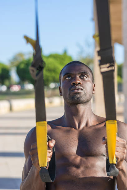istock male muscular training with system trx 854495380