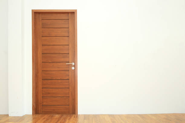 istock Wooden door in empty room 854498084