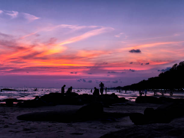 istock Twilight and sunset at the sea witj a man taking photo 854504208