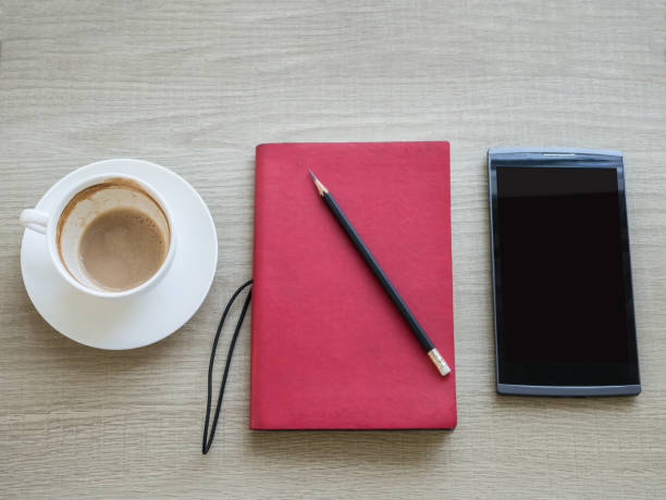 istock A cup of coffee with notebook and tablet on table 854504784