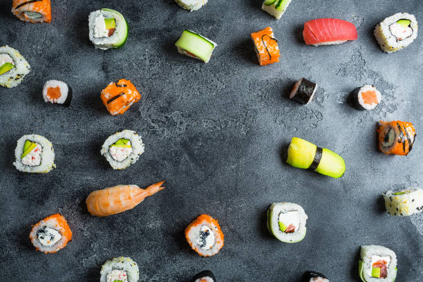 istock Pattern of sushi rolls on a dark background. Japanese food 854510968