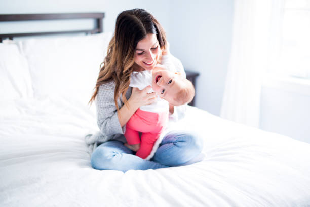 istock Mother and baby child on a white bed 854519628