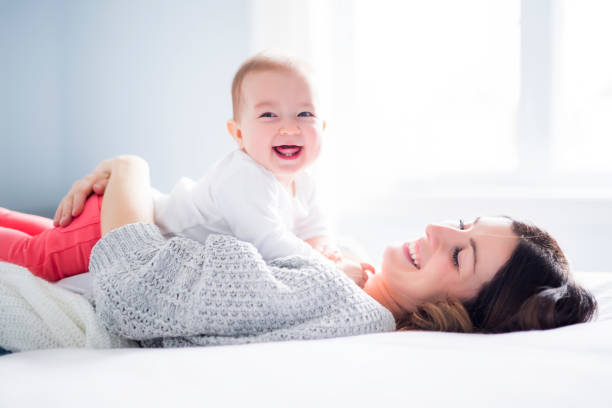 istock Mother and baby child on a white bed 854522742