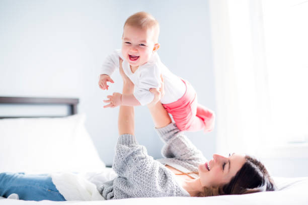 istock Mother and baby child on a white bed 854524104