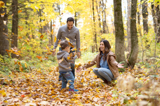istock Happy family relaxing outdoors In autumn park 854525476