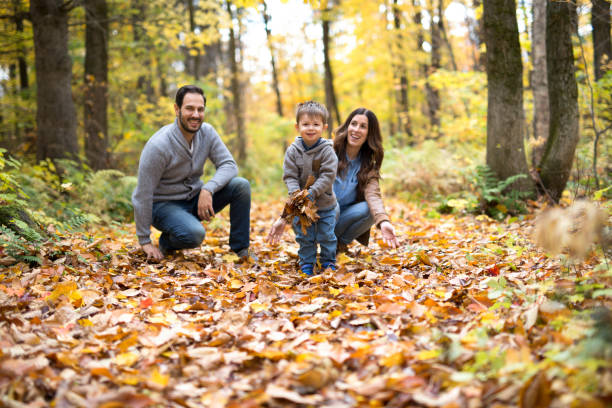 istock Happy family relaxing outdoors In autumn park 854525668