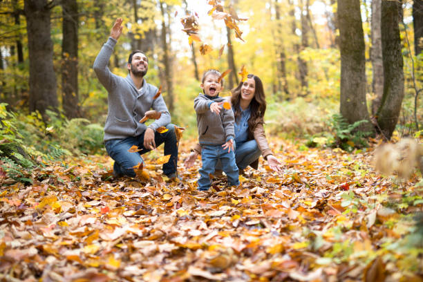istock Happy family relaxing outdoors In autumn park 854525706