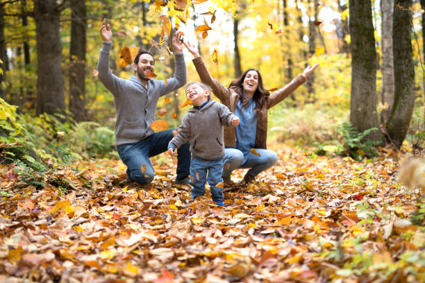 istock Happy family relaxing outdoors In autumn park 854525762