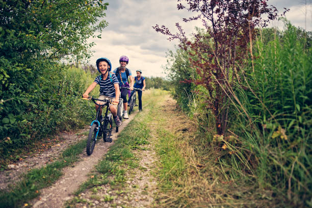 istock Family riding bicycles on dirt road 854525886