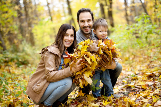 istock Happy family relaxing outdoors In autumn park 854528400