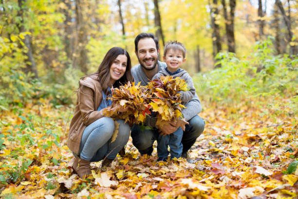 istock Happy family relaxing outdoors In autumn park 854528546