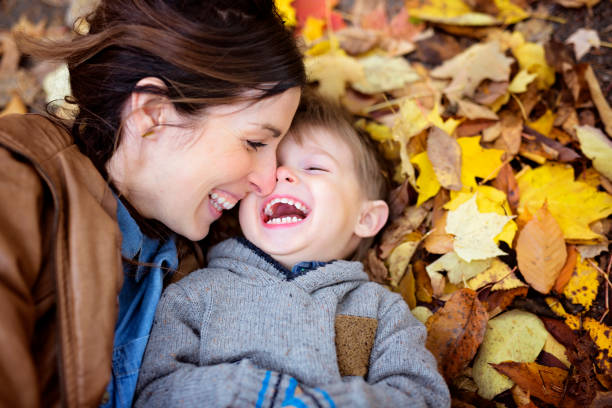 Mother with son in forest in autumn