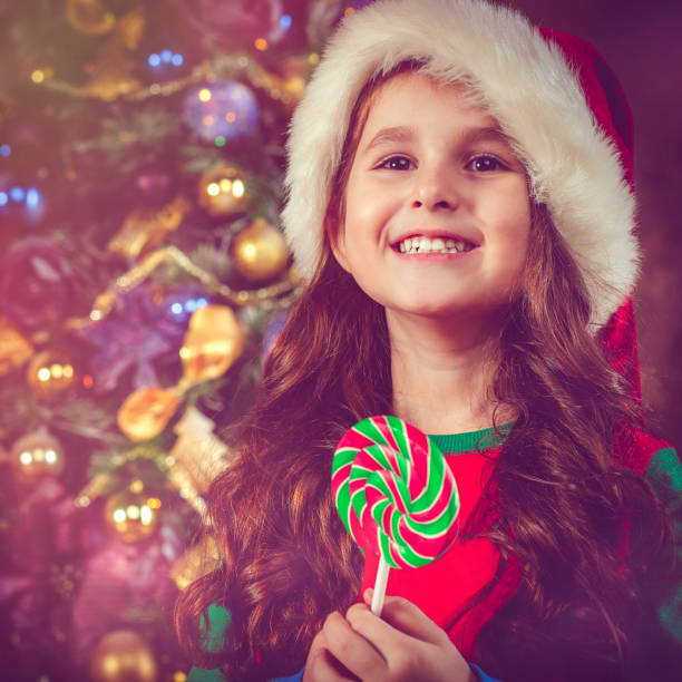 istock Child with lollipop in Christmas 854529786
