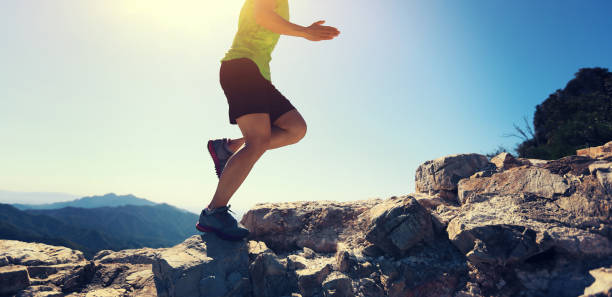 istock woman trail runner running at mountain top 854539718