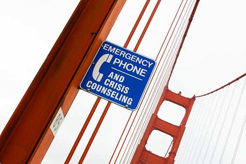 Suicide Prevention and help signed on the Golden Gate Bridge, San Francisco, California, USA