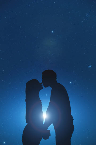 Silhouettes of a young couple under the starry sky. My astronomy work. Silhouettes of a young couple under the starry sky. My astronomy work. stars in your eyes stock pictures, royalty-free photos & images