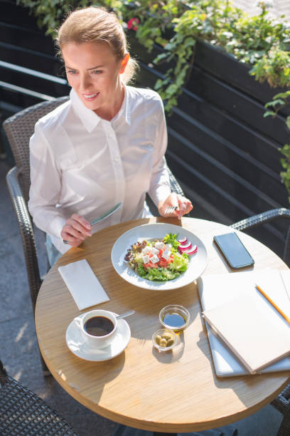 istock Beautiful woman having salad in a restaurant 854560022