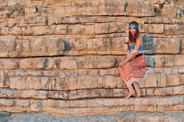 istock Young bikini girl posing on the rocks 854565204