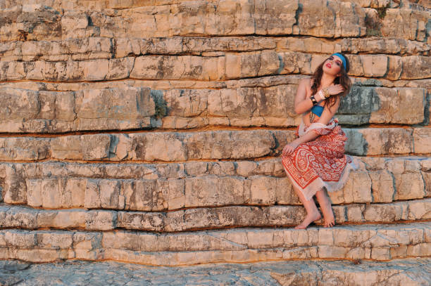 istock Young bikini girl posing on the rocks 854565270
