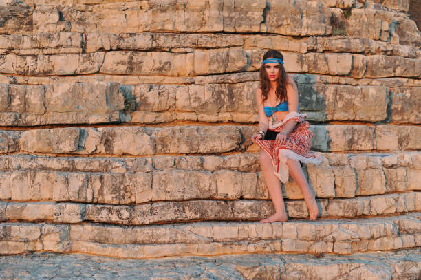 istock Young bikini girl posing on the rocks 854565590