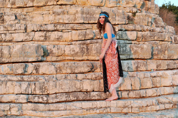 istock Young bikini girl posing on the rocks 854565864
