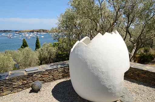 Portlligat, Spain - July 27, 2017: Egg sculpture at the garden of the summer house of the painter Dali in  Portlligat, a small village on the Costa Brava of the Mediterranean Sea, in the municipality of Cadaques, Girona, Catalonia, Spain.