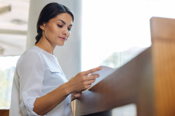 istock Delicate young woman reading at the cafe counter 854566624