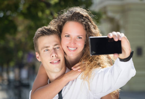 istock young couple selfy on street 854576396