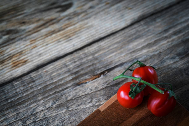 istock tomatoes on rustic wooden table, Top view, place for typography 854576816