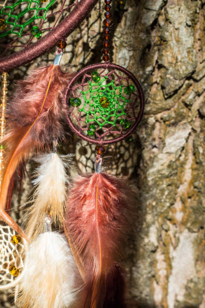 istock Handmade dream catcher with feathers threads and beads rope hanging 854578240