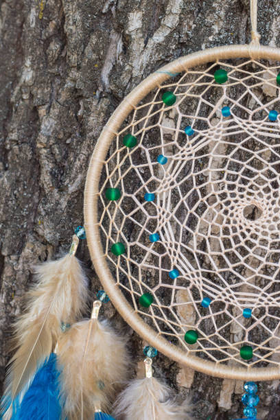 istock Handmade dream catcher with feathers threads and beads rope hanging 854578244