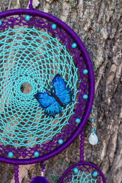 istock Handmade dream catcher with feathers threads and beads rope hanging 854578376