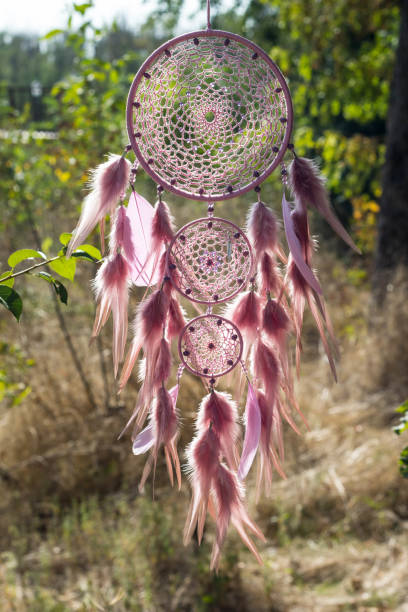 istock Handmade dream catcher with feathers threads and beads rope hanging 854581648