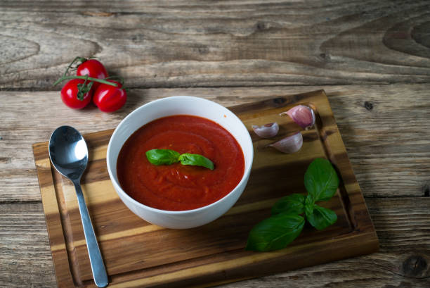 istock Tomato soup on wooden table, top view 854582226