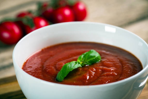 istock Tomato soup on wooden table, top view 854582306