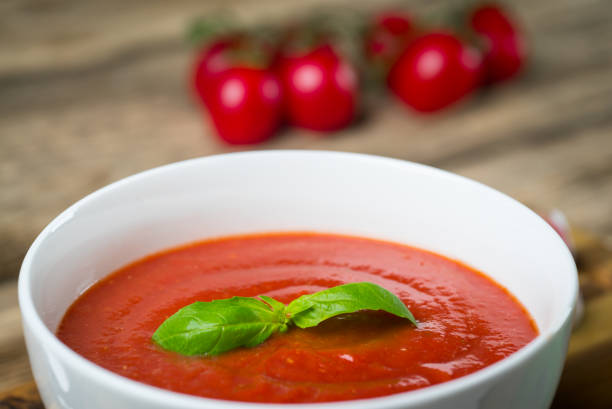 istock Tomato soup on wooden table, top view 854582374